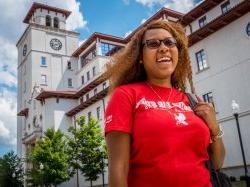 Student smiling outside of University Hall